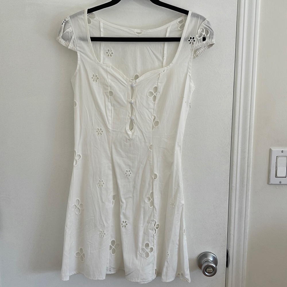 white dress with flower cut outs